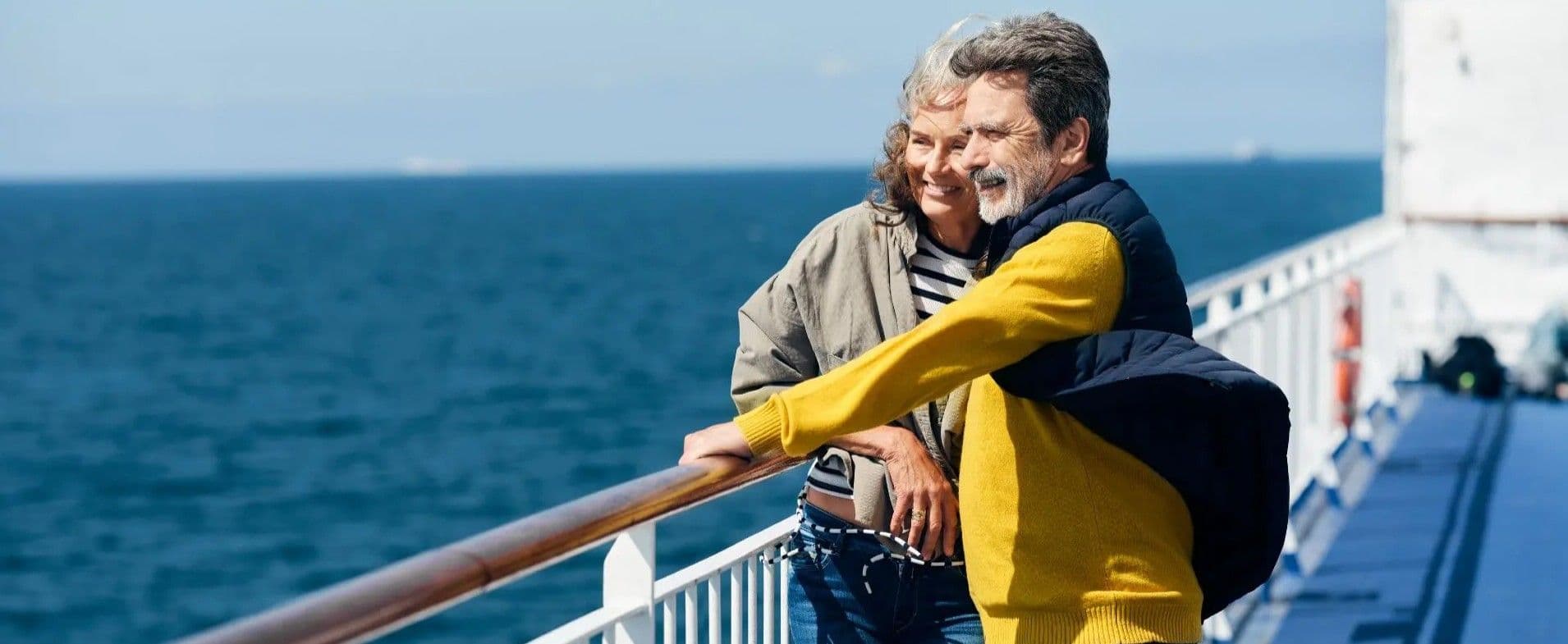 Man and woman enjoying fresh air on the ferry deck